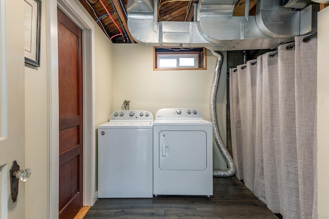laundry room with laundry area, dark wood finished floors, and washing machine and dryer