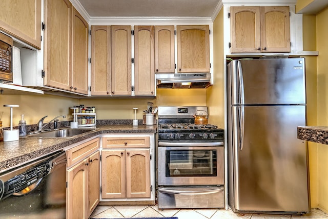 kitchen with light tile patterned floors, dark countertops, stainless steel appliances, under cabinet range hood, and a sink