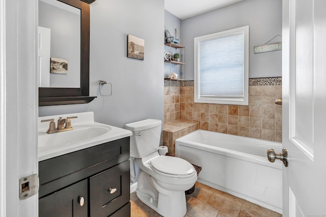 bathroom with toilet, vanity, a bath, and tile patterned floors