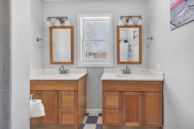 bathroom featuring two vanities, a sink, and tile patterned floors