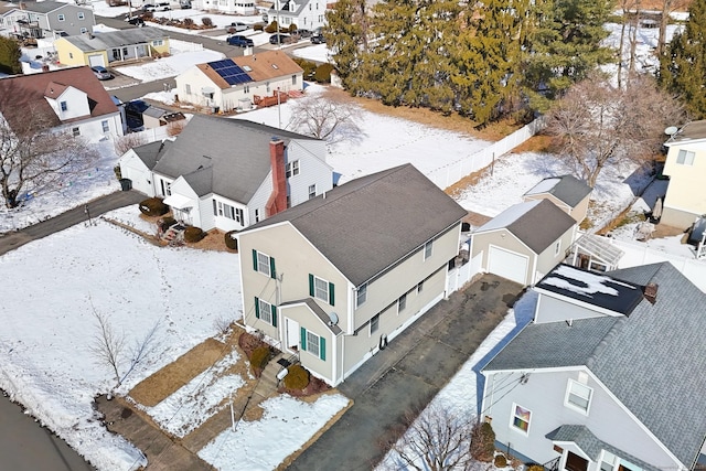 snowy aerial view featuring a residential view