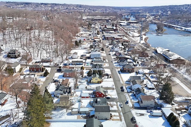 snowy aerial view featuring a residential view and a water view