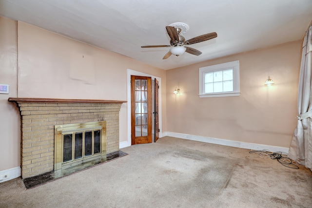 unfurnished living room featuring a fireplace, baseboards, carpet, and ceiling fan