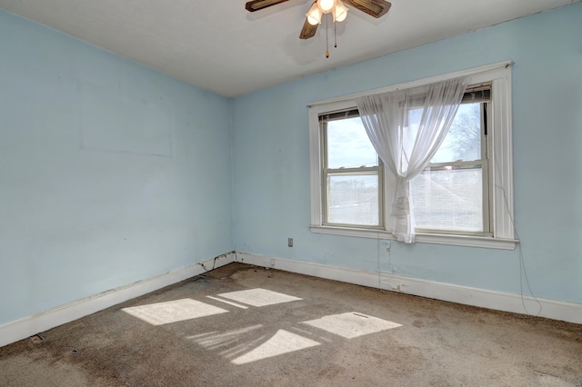 spare room featuring a ceiling fan, carpet, and baseboards