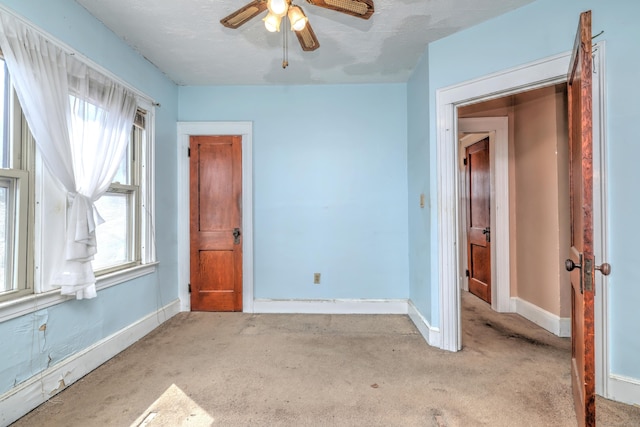 unfurnished bedroom with baseboards, ceiling fan, and carpet flooring