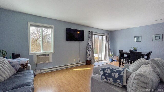 living area featuring a baseboard radiator and wood finished floors