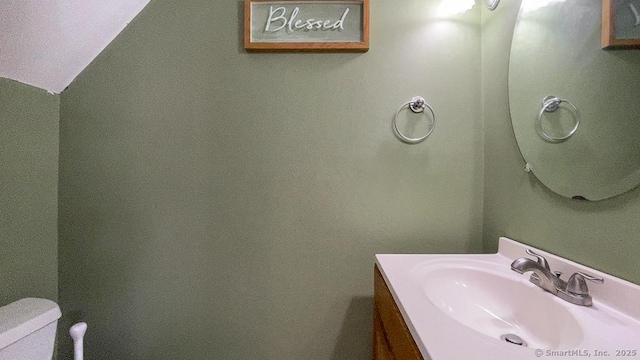 bathroom featuring toilet and vanity