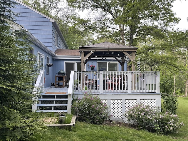 rear view of house with a gazebo and a deck