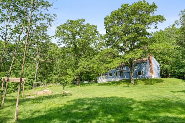 view of yard with a view of trees