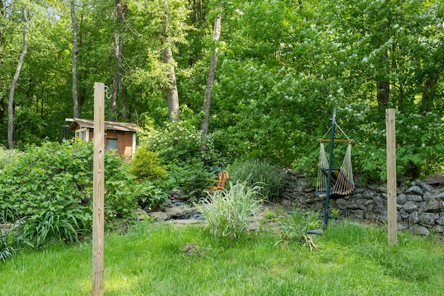 view of yard with a storage unit and an outbuilding