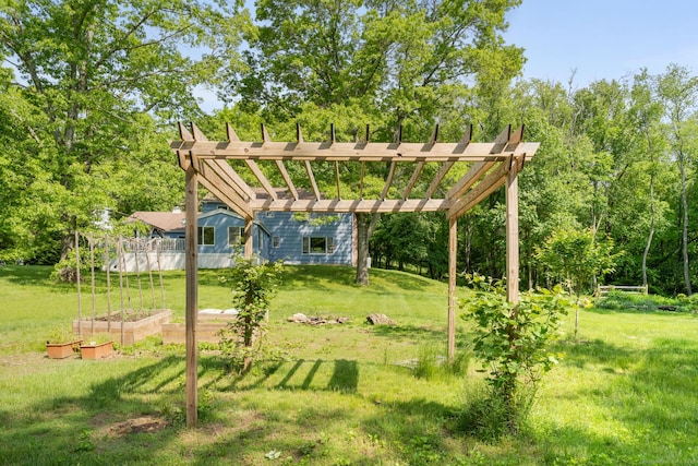 view of property's community featuring a lawn and a garden