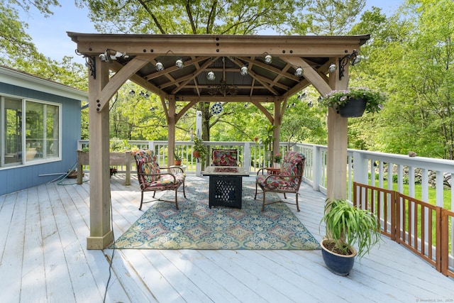 deck with a fire pit and a gazebo