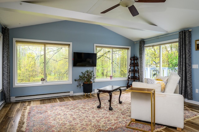 sitting room with a healthy amount of sunlight, lofted ceiling with beams, and a baseboard heating unit