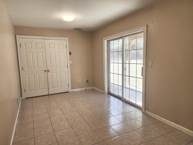 entryway with light tile patterned floors, visible vents, and baseboards