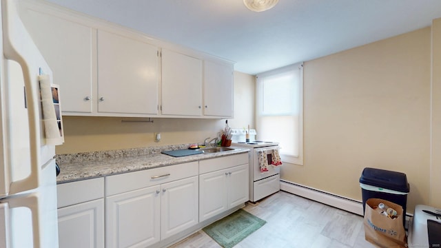 kitchen with white appliances, white cabinetry, a sink, and baseboard heating