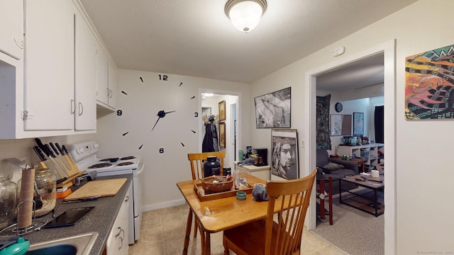 dining area featuring light tile patterned floors and baseboards