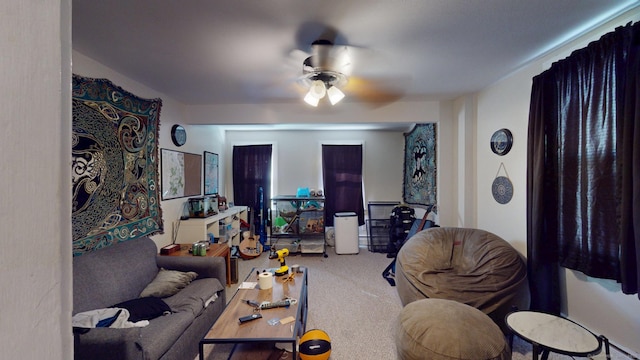 carpeted living area featuring ceiling fan