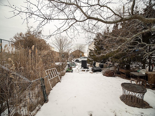 yard layered in snow with fence