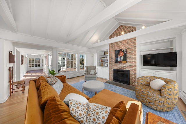 living area featuring vaulted ceiling with beams, a brick fireplace, light wood-style flooring, and built in features