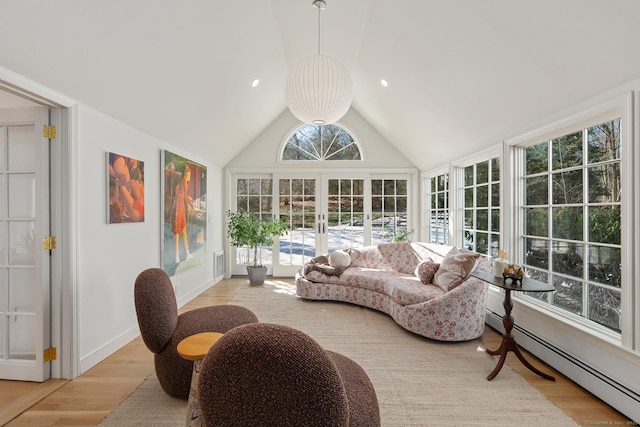 sunroom featuring lofted ceiling, french doors, and baseboard heating