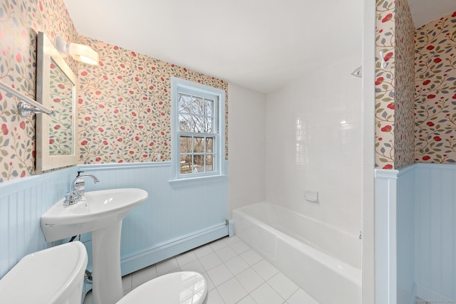 full bathroom with a baseboard heating unit, a wainscoted wall, toilet, and wallpapered walls