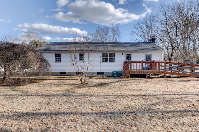 rear view of house with a wooden deck and a chimney