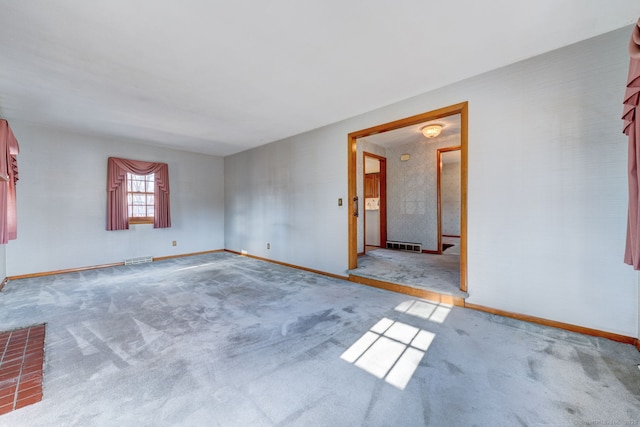 carpeted empty room with visible vents and baseboards