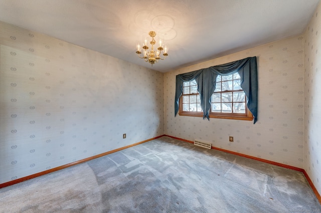 spare room featuring visible vents, an inviting chandelier, carpet flooring, wallpapered walls, and baseboards