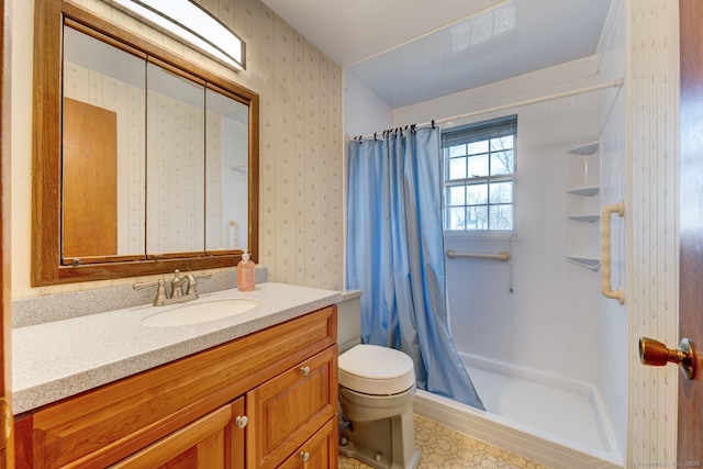 bathroom with wallpapered walls, toilet, vanity, and a stall shower