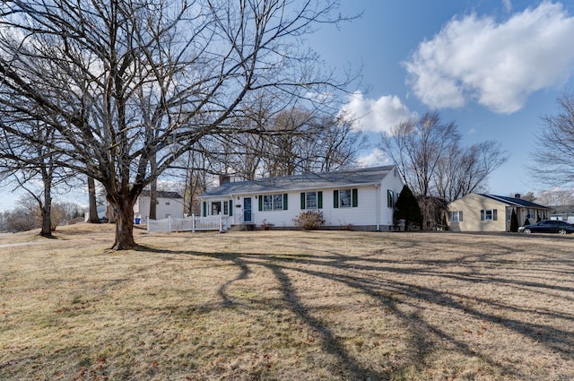 view of front of property featuring a chimney and a front lawn