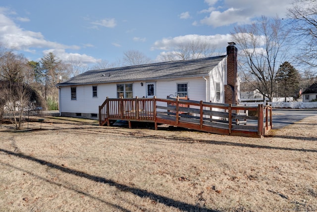 back of house featuring a wooden deck and a chimney