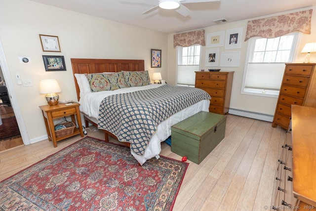 bedroom with visible vents, baseboards, ceiling fan, light wood-type flooring, and a baseboard heating unit