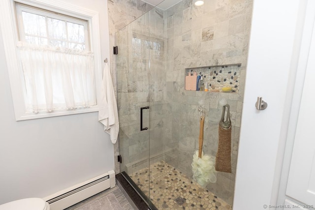 bathroom with a stall shower, a baseboard radiator, and toilet