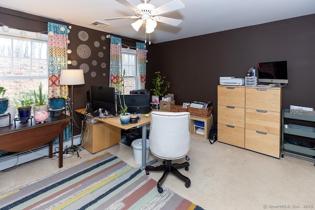 office space with light colored carpet, visible vents, and a ceiling fan