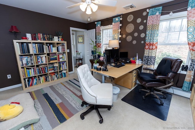 home office featuring baseboards, a ceiling fan, visible vents, and a healthy amount of sunlight