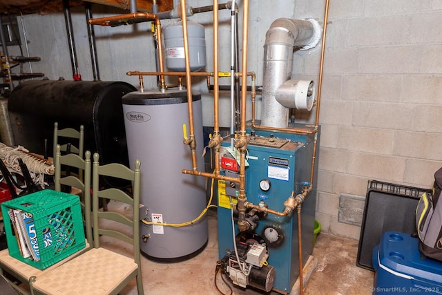 utility room with water heater, a heating unit, and heating fuel