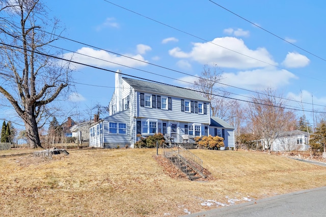 colonial-style house with a front yard