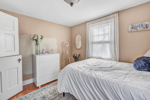 bedroom featuring wood finished floors and baseboards