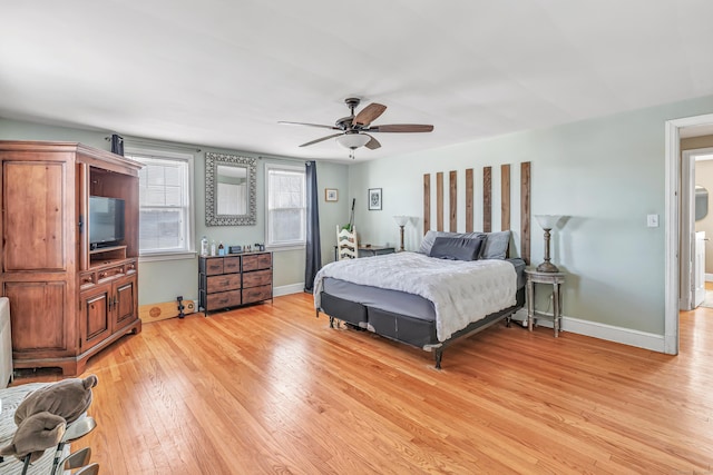 bedroom featuring light wood-style floors, ceiling fan, and baseboards