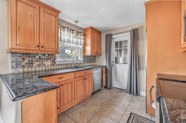 kitchen featuring light tile patterned floors, tasteful backsplash, appliances with stainless steel finishes, decorative light fixtures, and a sink