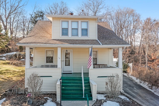 bungalow-style house with covered porch and roof with shingles