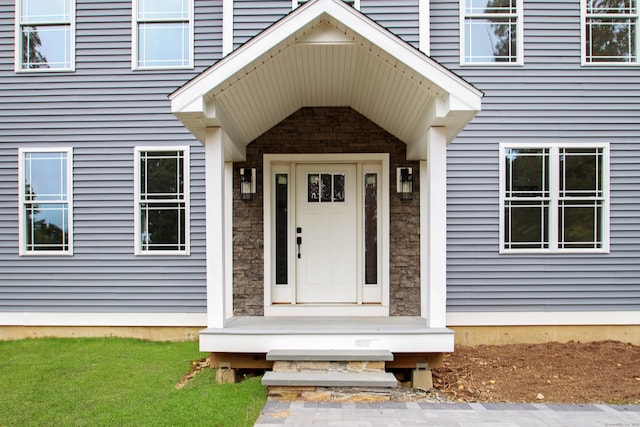 property entrance featuring stone siding