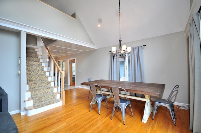 dining space featuring light wood-type flooring, stairway, baseboards, and a chandelier