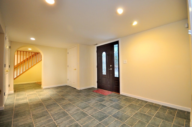 foyer featuring recessed lighting, stairs, and baseboards