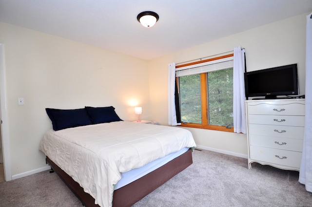 carpeted bedroom featuring baseboards