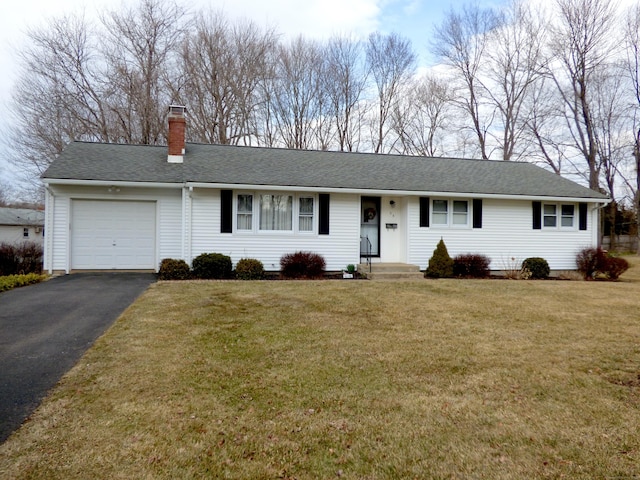 single story home featuring a chimney, a shingled roof, a front yard, a garage, and driveway