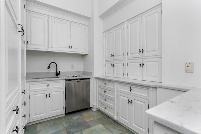 kitchen featuring stainless steel dishwasher, light countertops, white cabinetry, and a sink