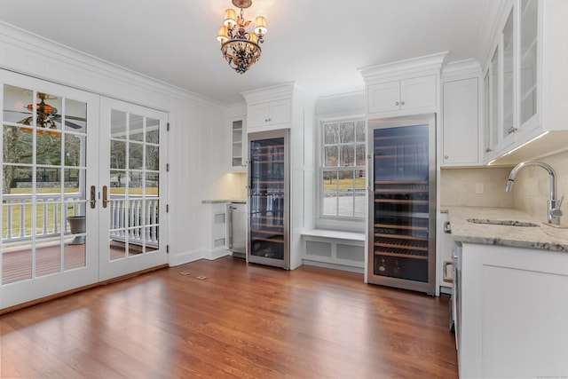 kitchen featuring a sink, wine cooler, french doors, white cabinetry, and dark wood-style flooring