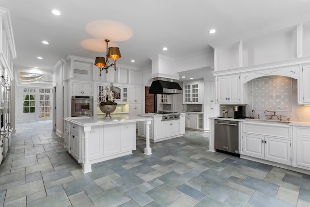 kitchen with a sink, white cabinets, appliances with stainless steel finishes, and a kitchen island