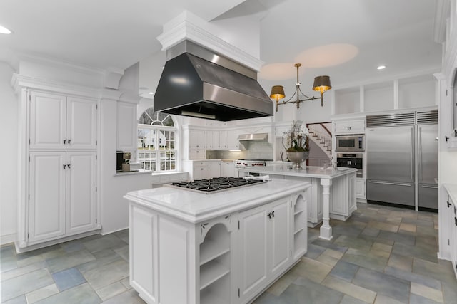 kitchen with range hood, a kitchen island, open shelves, light countertops, and built in appliances